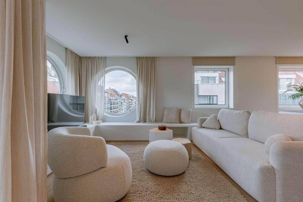 een woonkamer met een bank en twee stoelen bij Huswell - Luxurious apartment on top location in Knokke in Knokke-Heist