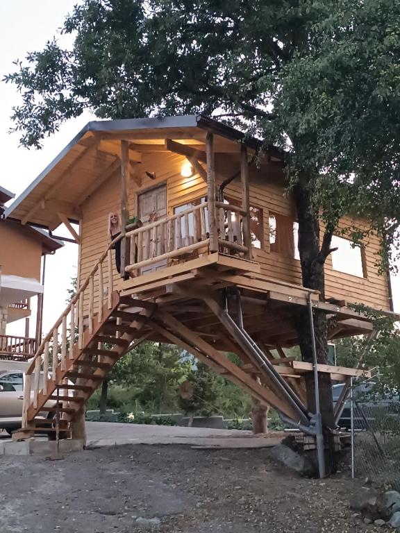 ein Baumhaus mit einer großen Holzterrasse in der Unterkunft La Moara Boutique Hotel in Kraniá