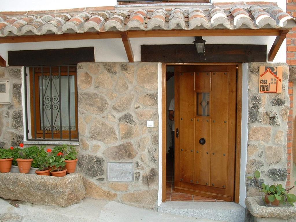 an entrance to a stone building with a wooden door at Casa Rural Cendal in Navacarros