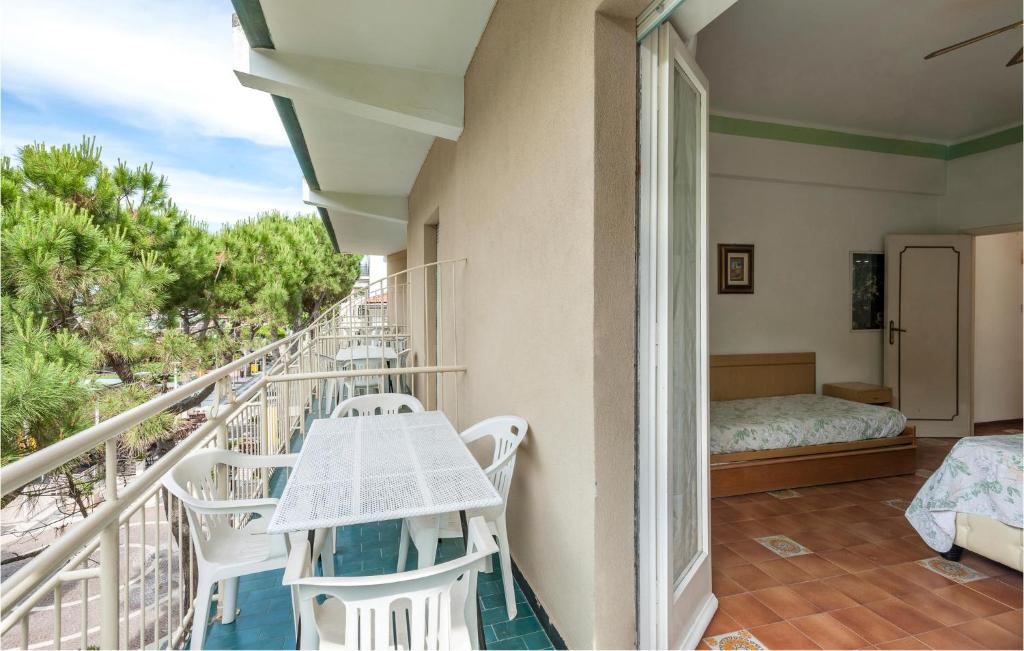 a balcony with a table and chairs and a bed at Nice Apartment In Cattolica With Wifi in Cattolica