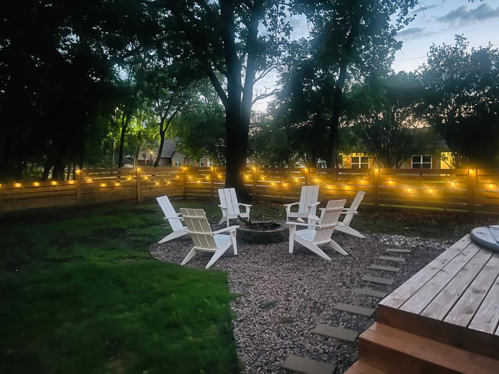 a group of white chairs sitting around a fire pit at The Hickory House with Firepit- Boat Ramp Access to Cedar Creek Lake in Tool