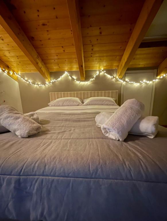 a bedroom with a large bed with lights on it at Casa Margot in Asti