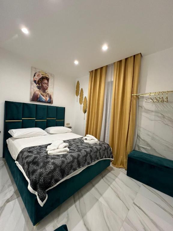 a bedroom with a bed with a black and white blanket at Familia in Naples