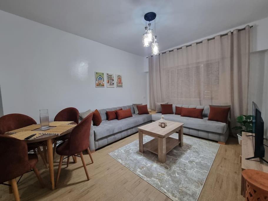 a living room with a couch and a table at Spacious and Modern 2BR Apartment Rabat center in Rabat