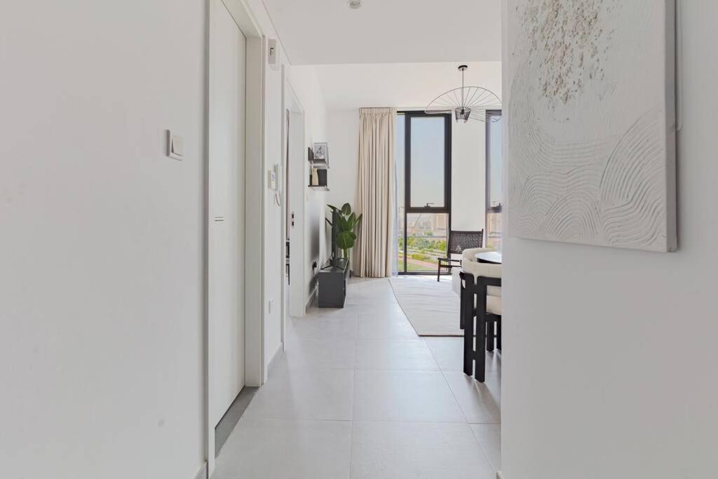 a hallway with a table and a dining room at Sahab - courtyard view 1BR in Sharjah