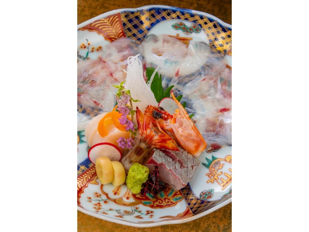 a plate of food with sushi and vegetables on it at Shiseki Ryokan Kagetsu Taishoukan - Vacation STAY 48535v in Takeo