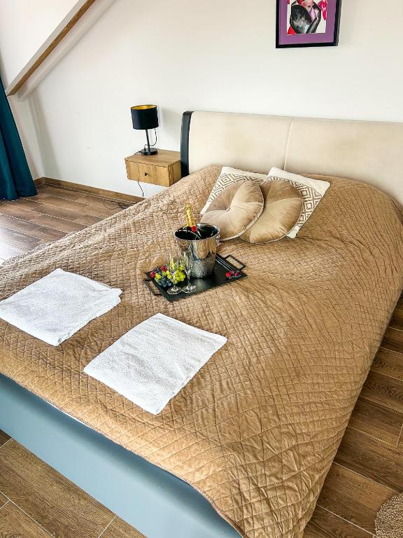 a bed with two pillows and a tray of food on it at Aquarius Stawy 11 in Grodzisk Mazowiecki