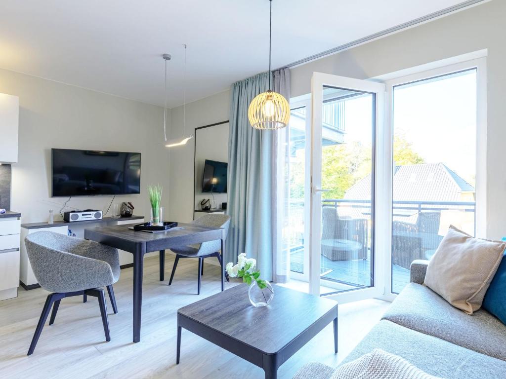 TV a/nebo společenská místnost v ubytování Kleine Strandperle - Ihr Ferienapartment zwischen Ostsee und Bodden