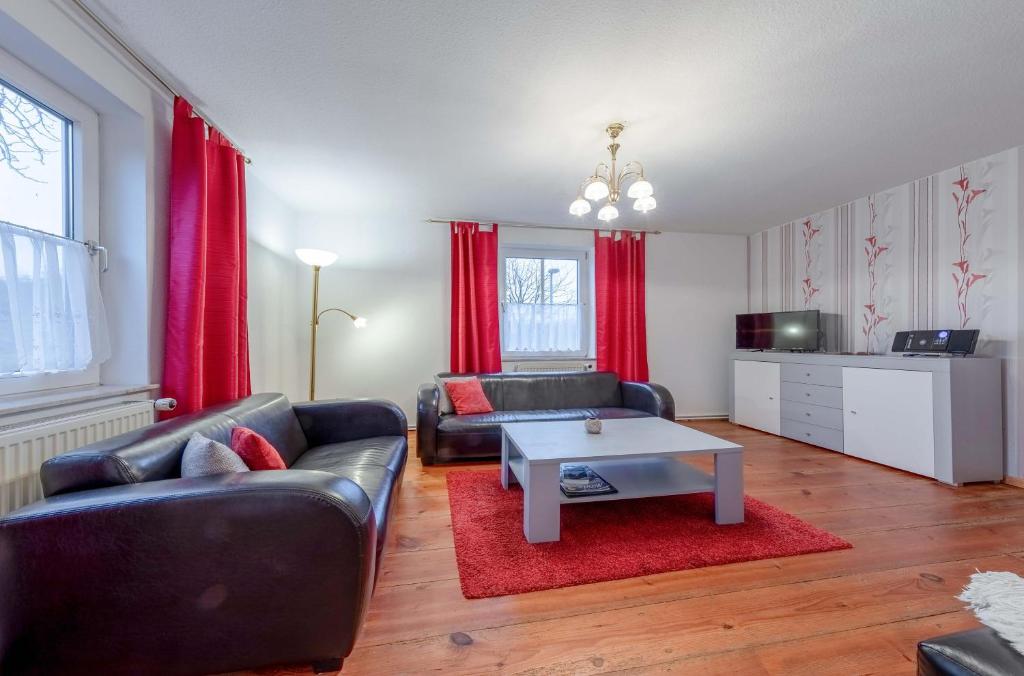 a living room with a couch and a coffee table at Rohrdommel - Seeoase am Loopiner See in Jabel