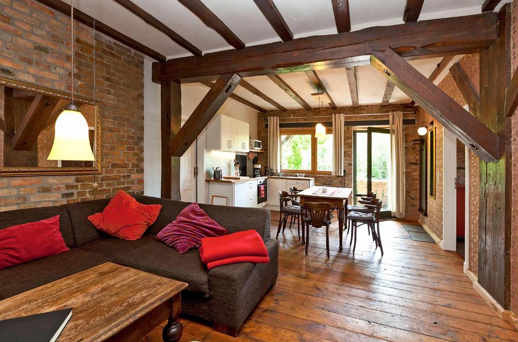 a living room with a couch and a dining room at Ferienwohnung Lilie mit Balkon in einer geschmackvoll sanierten Backsteinmühle in Waren