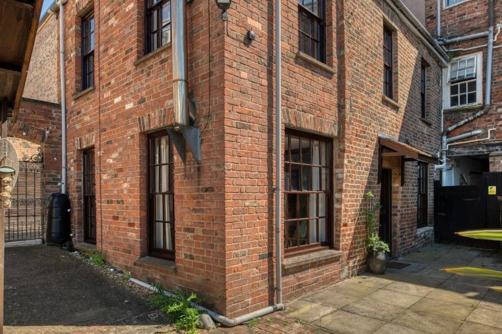 a brick building with windows on the side of it at Grade II Listed Cottage in Central Taunton in Taunton
