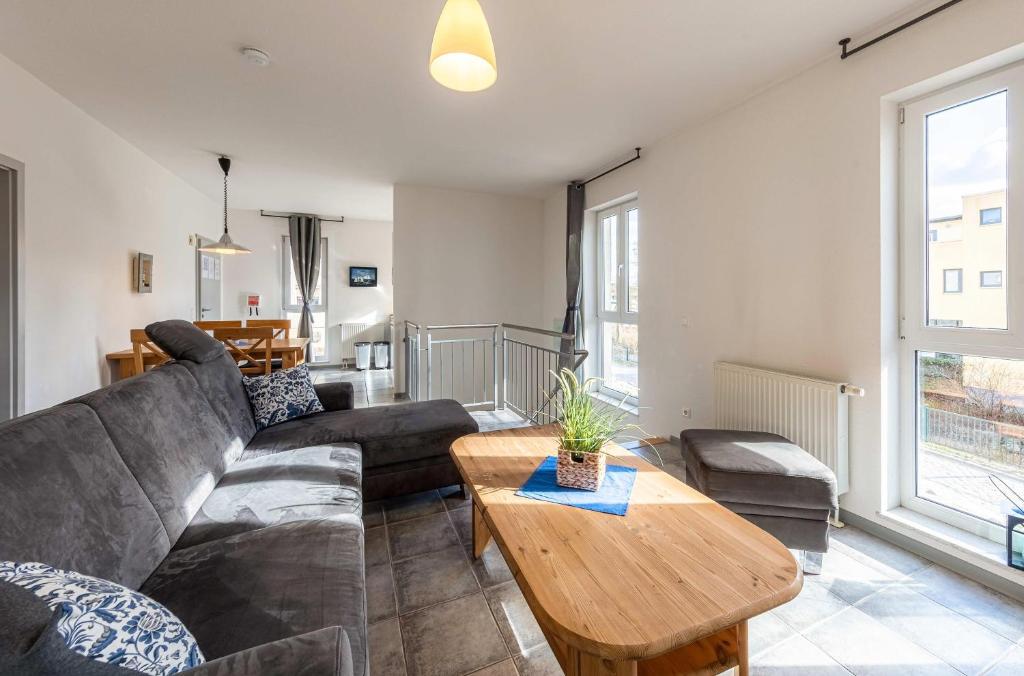 a living room with a couch and a table at Ferienwohnung Siegel am Müritzufer in Waren