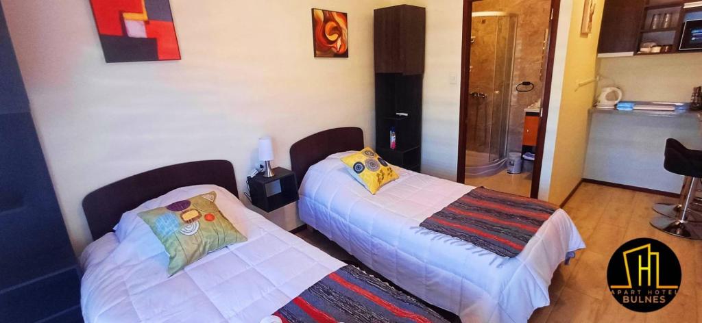 Postel nebo postele na pokoji v ubytování APART HOTEL EN BULNES