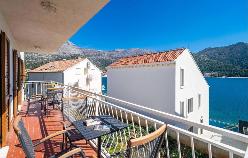 a balcony with chairs and a table and the water at Lovely Apartment In Slano With Wifi in Slano