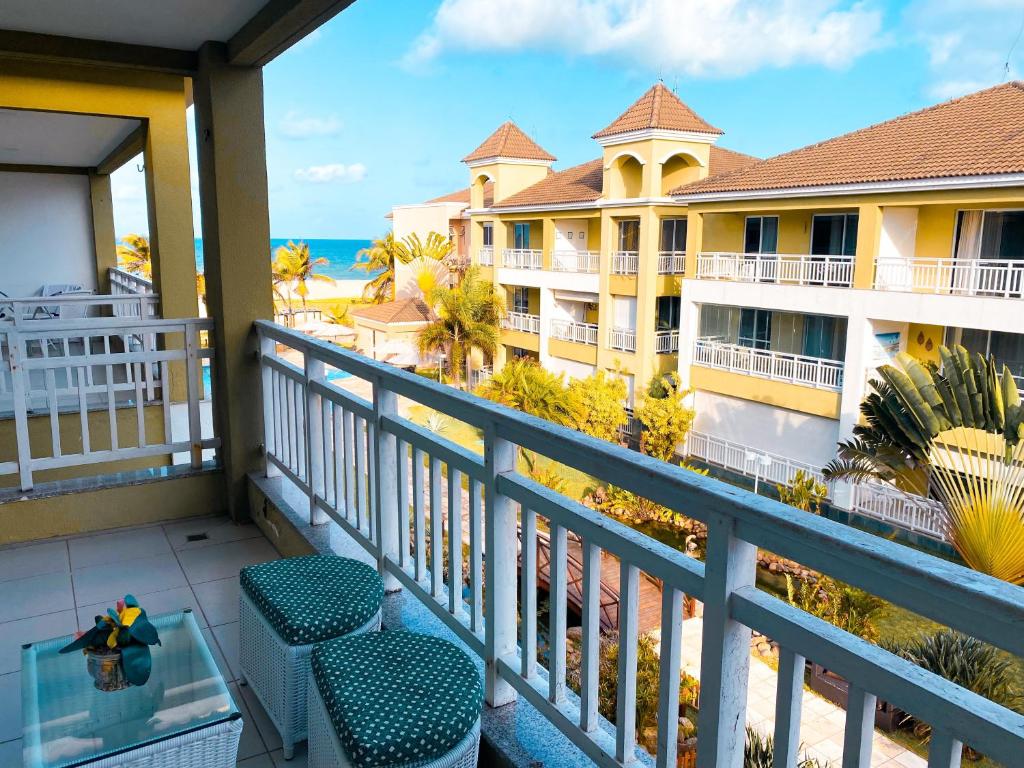 a balcony with a view of a hotel and the ocean at Planet Pé na Areia PDD in Aquiraz