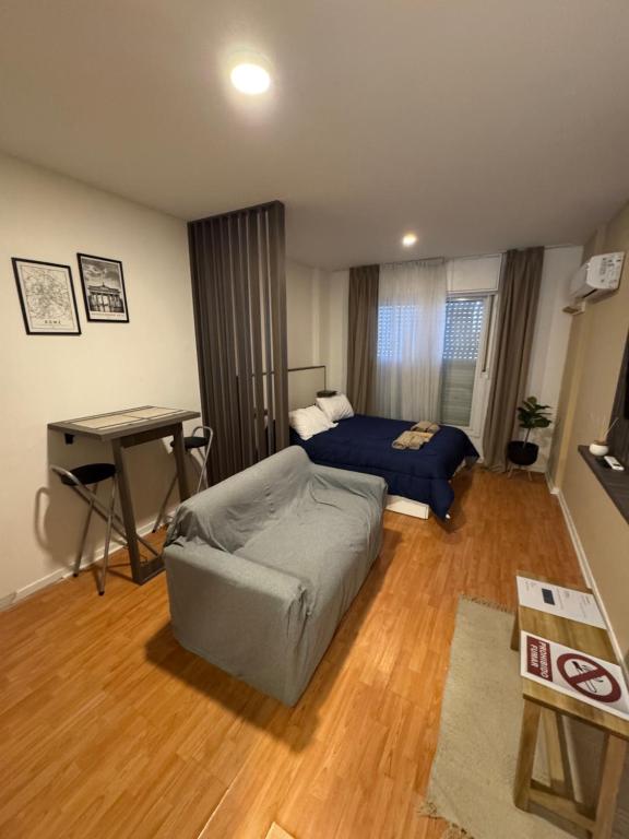 a living room with a bed and a desk at Departamento en Rosario centro 1 in Rosario