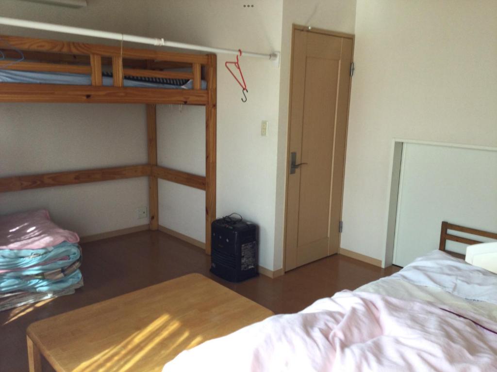 a bedroom with a bunk bed and a table at ichihara homestay-stay with Japanese family - Vacation STAY 17883 in Ichihara