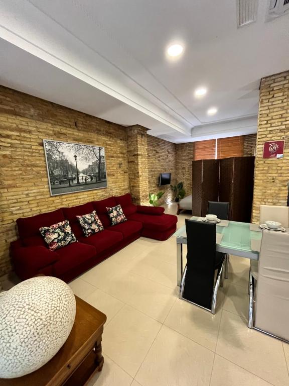 a living room with a red couch and a table at IY Loft 5 - Spacious Loft in the Old Town in Valencia