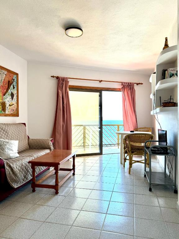 a living room with a couch and a table at Mangos Mar E in Puerto Naos
