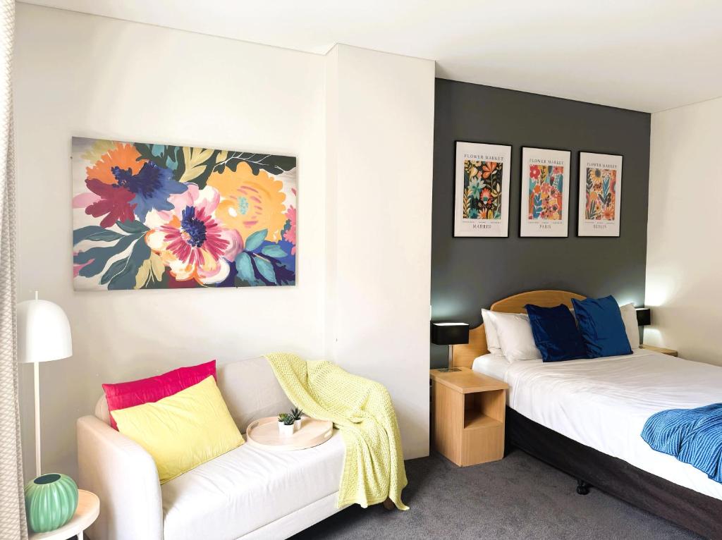 a room with two beds and a couch in it at 303 Cheerful City Central Crib Sleeps 2 in Perth