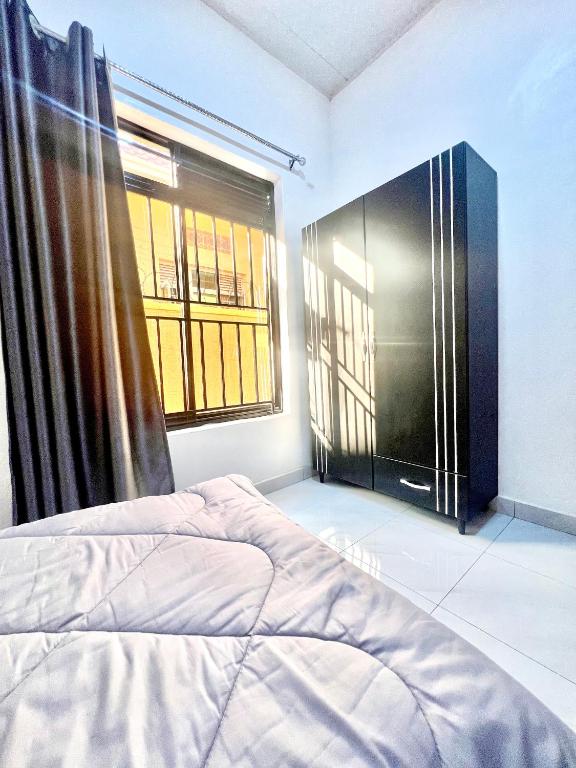 Un ou plusieurs lits dans un hébergement de l'établissement Rwanda Guest House Kanombe, Kigali