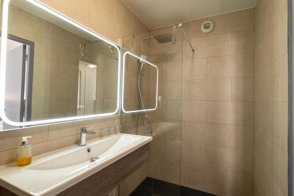Koupelna v ubytování Hotel Tambourin