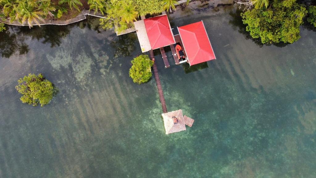 an aerial view of a house in the water at Akwaba Lodge in The Gap