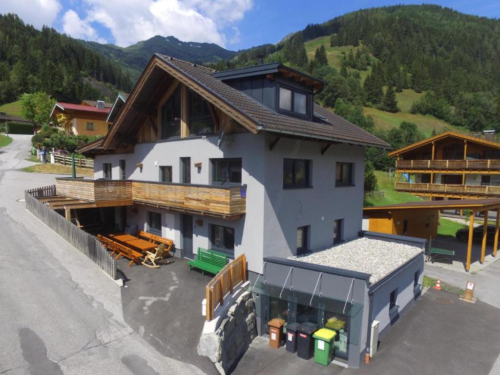 a large house with a roof in the mountains at Stacherl in Rauris