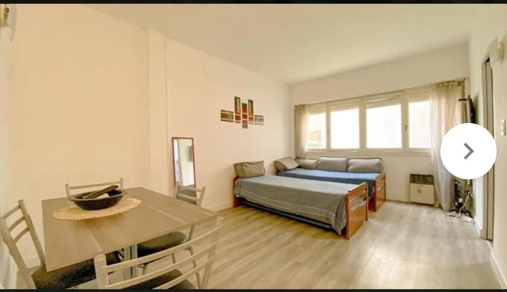 a bedroom with a bed and a table in it at Depto 1 ambiente in Mar del Plata