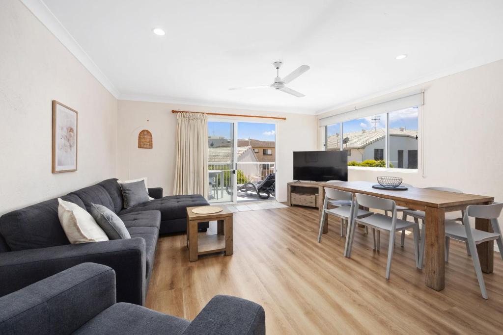 a living room with a couch and a table at 4 Blairgowrie Apartments 4 of 2 Martin Street in Peregian Beach in Peregian Beach