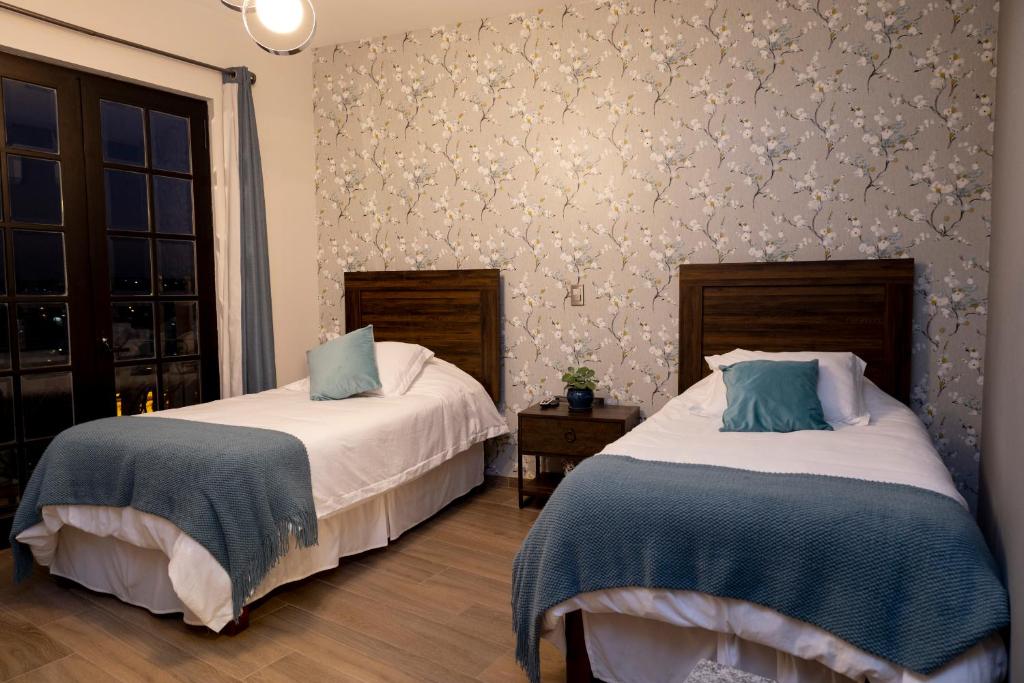 Postel nebo postele na pokoji v ubytování Casa Mia Suite San Juan de los Lagos