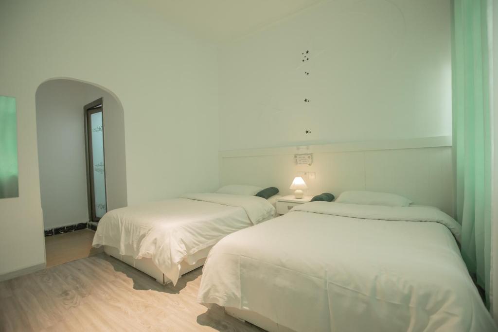 Postel nebo postele na pokoji v ubytování Lumingju Homestay