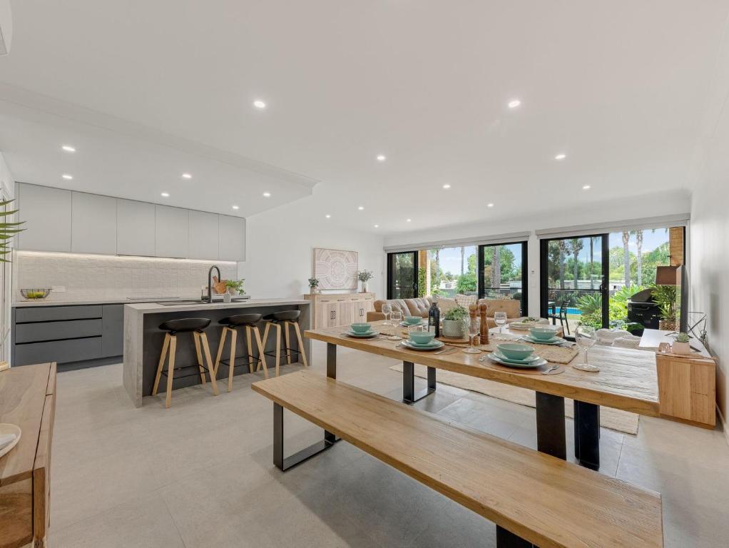 a kitchen and dining room with a wooden table at Elsinor 6 in Mulwala