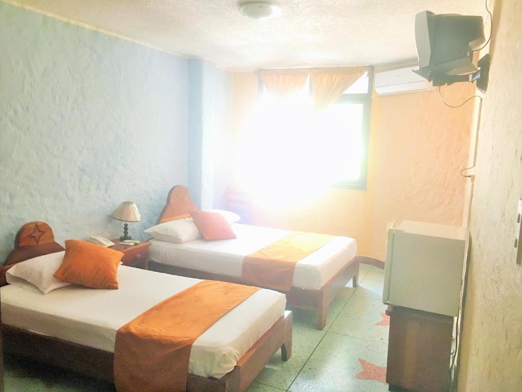 Postel nebo postele na pokoji v ubytování Hostal Estrella de Mar