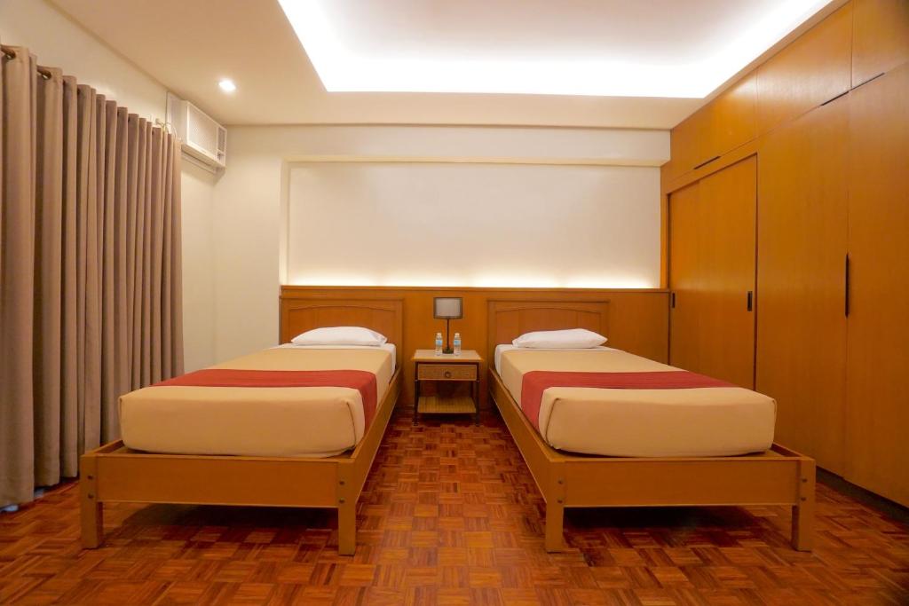 Postel nebo postele na pokoji v ubytování Tropicana Suites