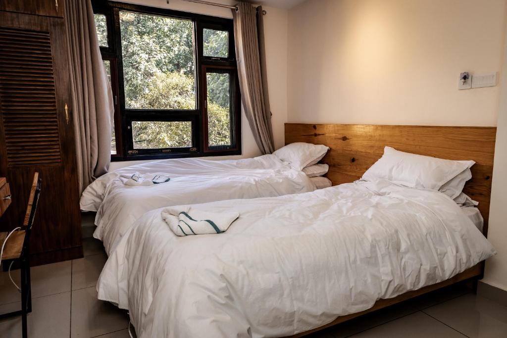 Postel nebo postele na pokoji v ubytování Sinpa Home Pilachhen