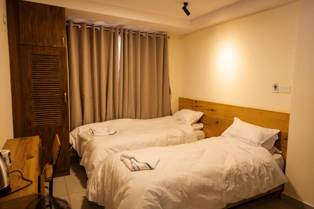 Postel nebo postele na pokoji v ubytování Sinpa Home Pilachhen