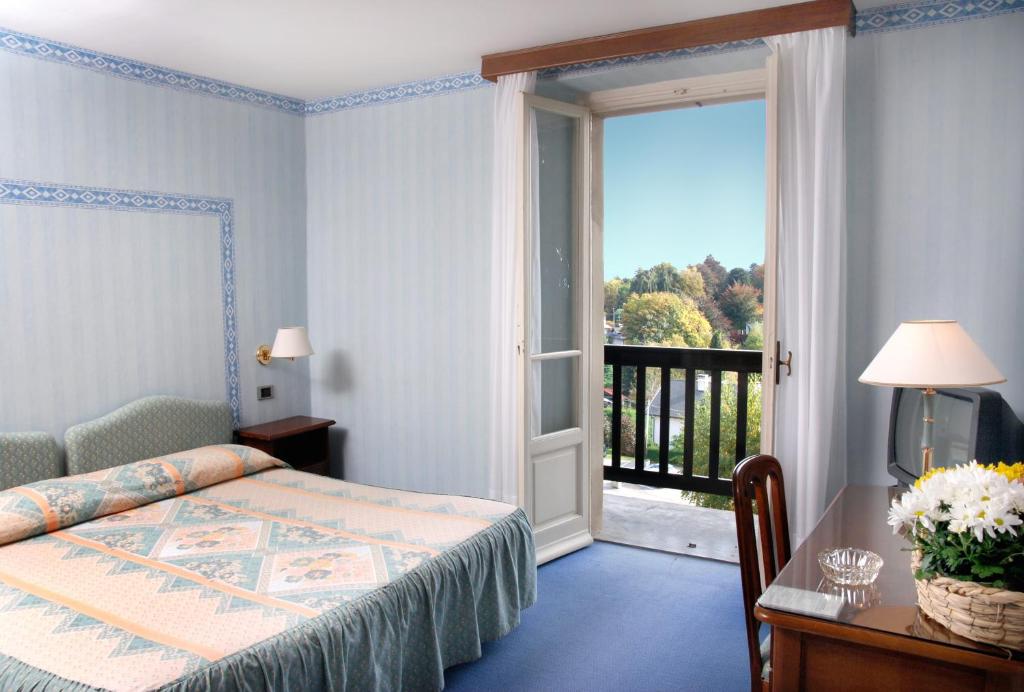 Postel nebo postele na pokoji v ubytování Hotel Moderno
