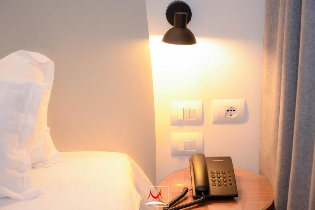 Postel nebo postele na pokoji v ubytování Hotel Theatro- City Center