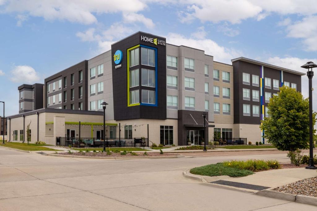 a large building with a sign on the front of it at Home2 Suites By Hilton Ankeny in Ankeny