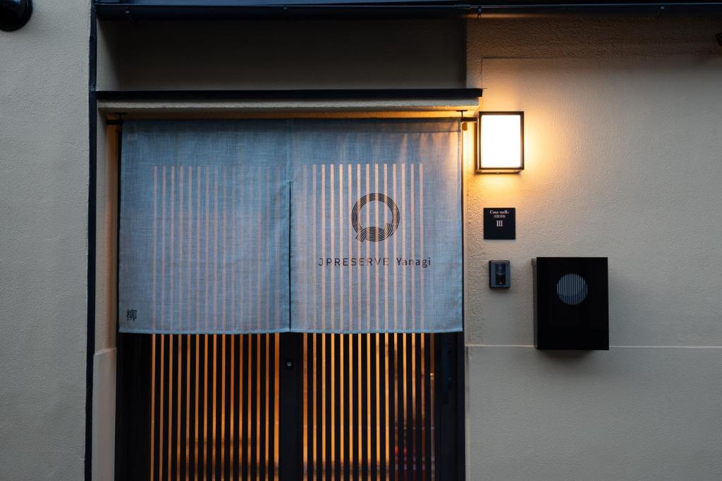 a door with a sign on it in a building at JPRESERVE Yanagi in Nishinotōindōri