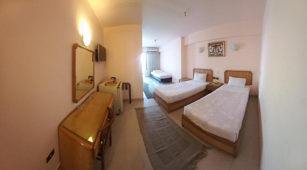 Postel nebo postele na pokoji v ubytování New Pola Hotel