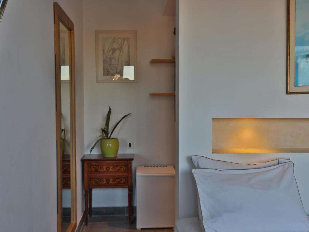 a bedroom with a bed and a table and a mirror at Dar Souad in La Marsa