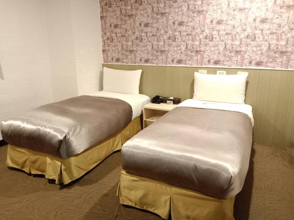 Postel nebo postele na pokoji v ubytování Ximen Hotel