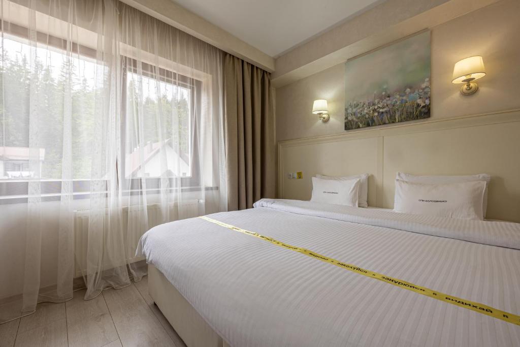 Postel nebo postele na pokoji v ubytování Helios Hotel & SPA