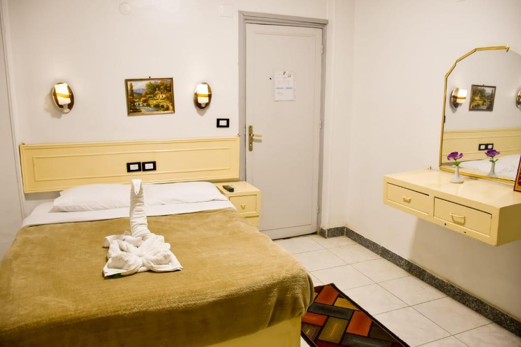 Postel nebo postele na pokoji v ubytování Oscar Hotel