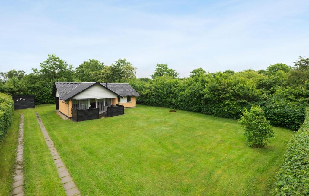 a small house in the middle of a yard at Gorgeous Home In Hemmet With Wifi in Hemmet