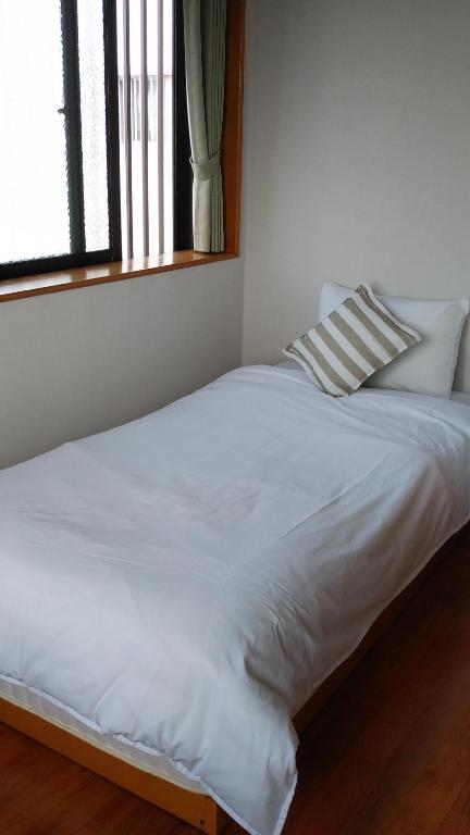 Llit o llits en una habitació de リンゴテラス壺屋