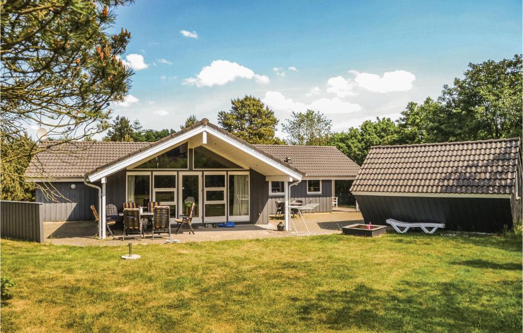 a home with a patio and a house at Holiday Home Møllevangen Oksbøl X in Ovtrup