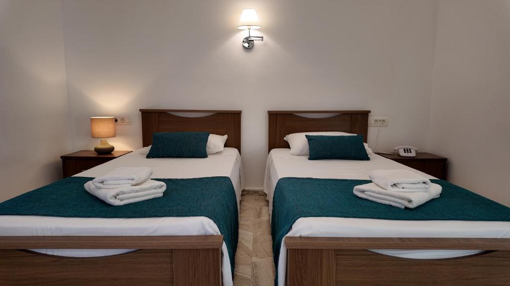 Postel nebo postele na pokoji v ubytování Hotel Marybill
